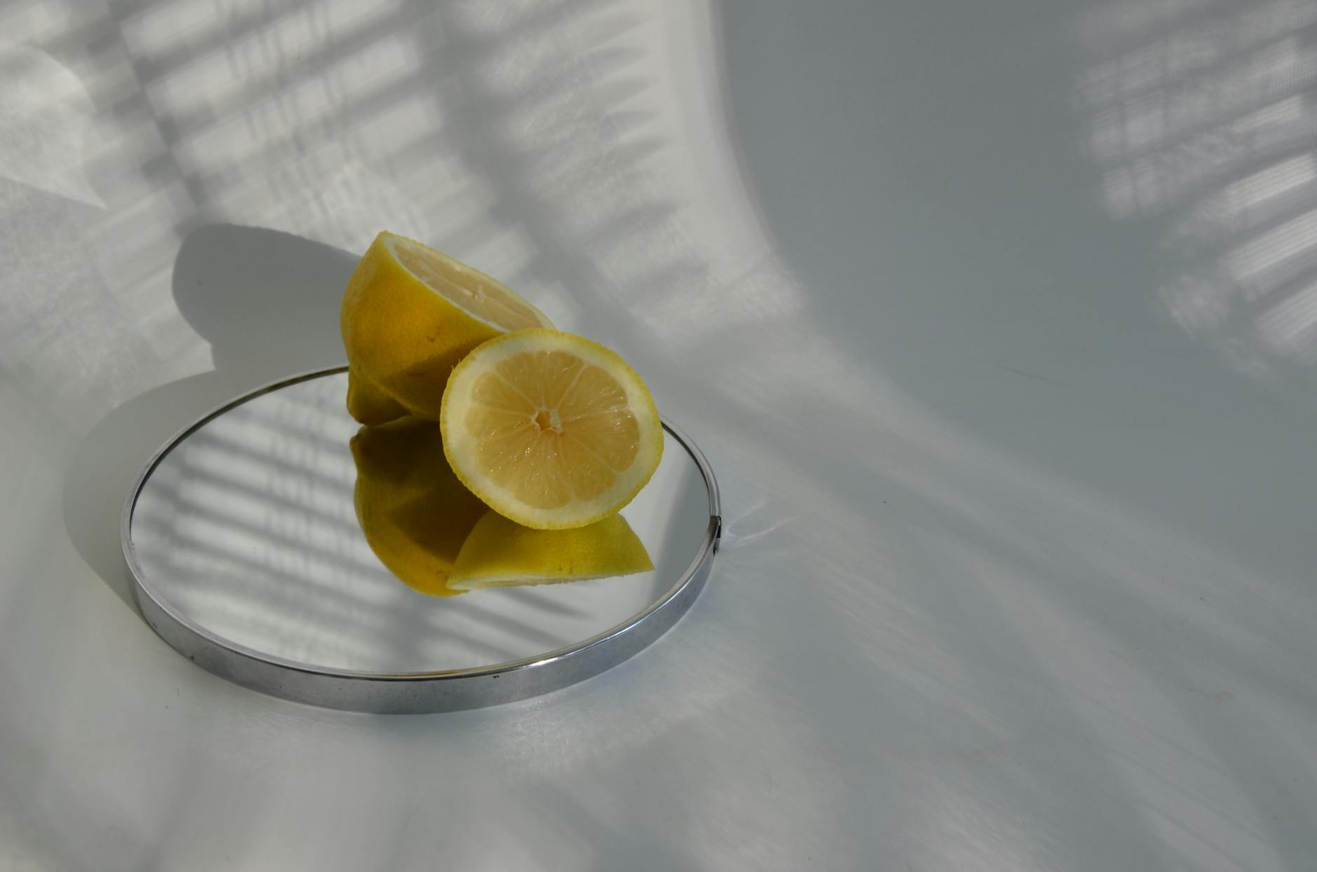 Yellow silicone vibrator surrounded by fresh bananas on bright yellow background