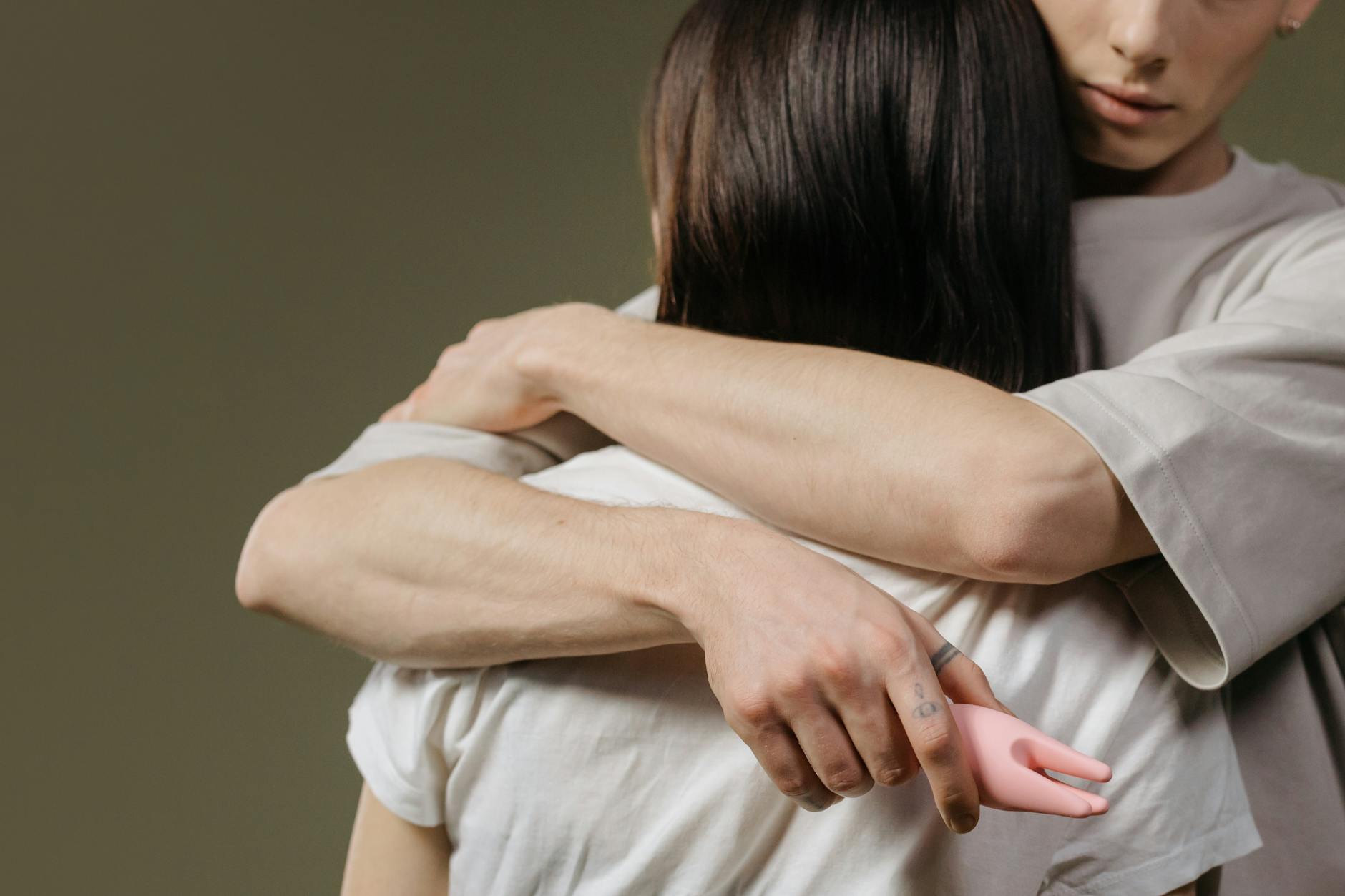 Close-up of hands holding together, depicting intimacy and physical connection during relationship transition